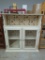 White Wooden Cabinet With Glass Doors and Apple Patterned Backing
