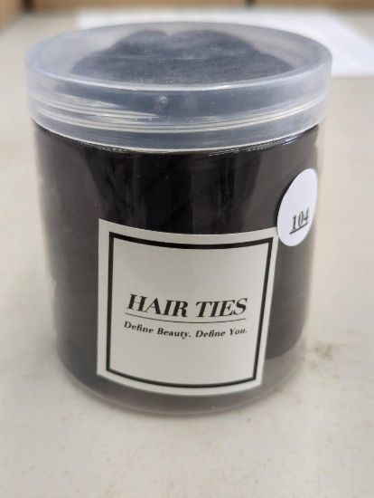 Container of Hair Ties with Label Define Beauty. Define You.