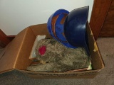 Items in Cardboard Box Including Helmets and Plush Toy