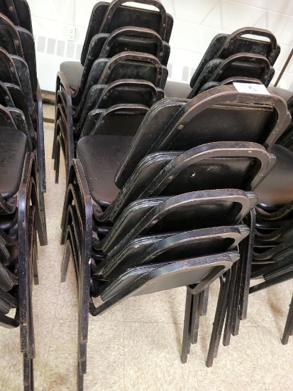 Stack of Black Cushioned Restaurant Chairs