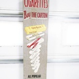 1950s Cigarettes Buy The Carton Vertical Tin Sign