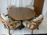 Round dining table with four chairs and two leaves
