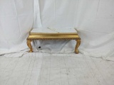 Gold wall mounted platform with white marble top.