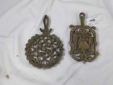 TWO BRASS COLORED TRIVETS, ONE IS A WILTON
