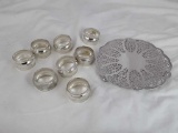 SILVERPLATE TRIVET AND 8 NAPKIN RINGS
