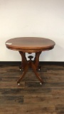 ANTIQUE OVAL PARLOR TABLE W/ORNATE LEGS ON CASTERS