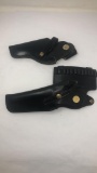 2 BLACK LEATHER HOLSTERS 1 WITH AMMO HOLDER.