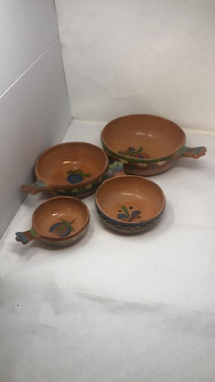 SET OF FOUR CLAY PAINTED STACKABLE HANDLED BOWLS