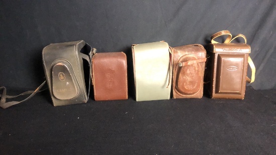 FIVE VINTAGE LEATHER STANDING CAMERA CASES
