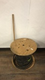 LARGE WOOD SPOOL OF INDUSTRIAL CABLE.