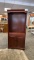 CHERRY COLORED WOOD BOOKCASE.