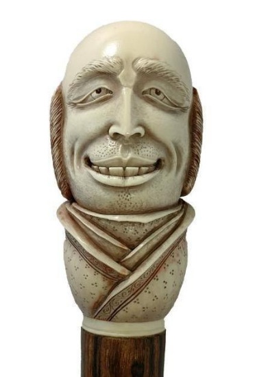 Bone or Tusk Engraved and Carved Exaggerated Expression Gentleman Cane on Wooden Shaft