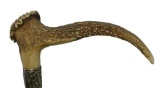 Stag Handled Cane with Many Silver and Mixed Metal Tags and Designs Along a Wooden Shaft
