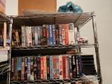 Assorted VHS Tapes on Top Three Shelves