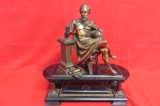 Bronze Statue of Man Holding Globe