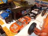 (2) RACE CARS, (1) MOBIL ONE RACING TRUCK & TRAILER COLLECTIBLE TOY