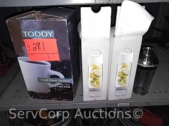 Lot on shelf of Toddy Cold Brew system, XD Design infuser bottles, mixer bottle