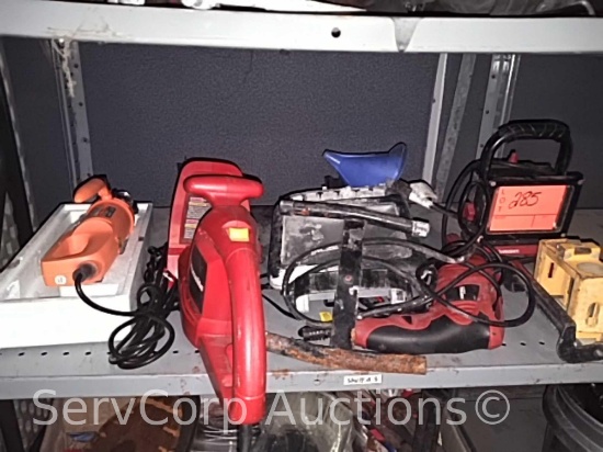 Lot on shelf of work lights, electric drill, electric hedge trimmer, electric cutout tool