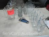 Lot of beer pitchers, mugs, glasses, bottle openers