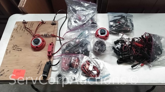 Lot on Shelf of Various Engine Stops, Low Volt Wire, 12-Volt Plug Adapters, Battery Clams, Power