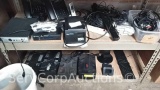 Lot on 2 Shelves of Various Landline Cordless Phones, Battery Back-ups, Board Reader, Star Receipt