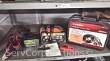 Lot on Shelf of Husky Booster Cables, Ampeak Smart Charger, Deltran Battery Tender Trickle Charger,