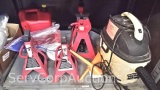 Lot on Shelf of Various Jack Stands, Funnels, Gas Can, Stanley 3-Gallon Wet/Dry Vac