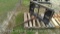 Lot on Pallet of Black Hay Spear Skidsteer Attachment