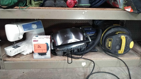Lot on Shelf of Stanley 5-Gallon Wet/Dry Vac, Dash Mini Grill Maker, Cuisinart Griddle, Brother