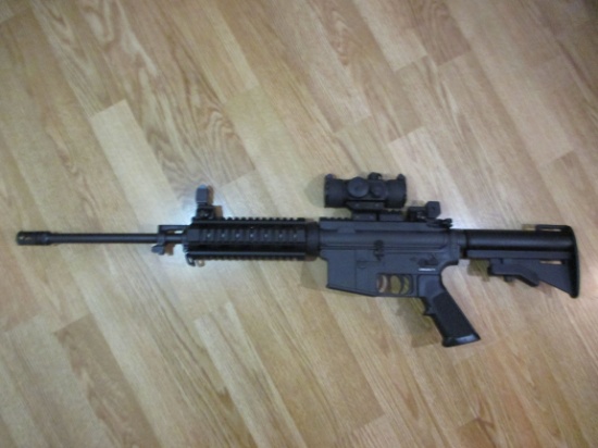 j-29 Bushmaster AR-15 223 caliber Semi Auto with Red dot sight. Like new with adjustable stock