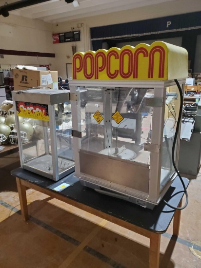 Two popcorn machines and table