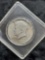 1964 Kennedy Half Dollar -hard plastic container, ungraded