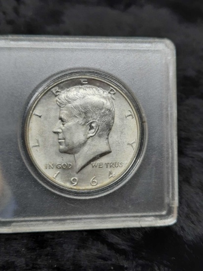 1964 Kennedy Half Dollar - hard plastic container, ungraded