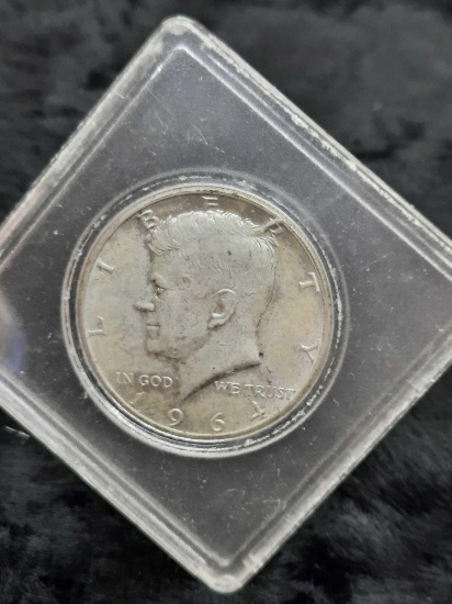 1964 Kennedy Half Dollar -hard plastic container, ungraded