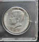 1964 Kennedy Half Dollar - hard plastic container, ungraded