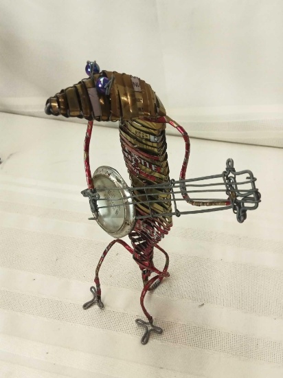 HANDMADE GECKO TYPE ANIMAL PLAYING BANJO MADE FROM TIN CANS AND WIRE. 9"TALL.