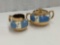 GIBSON ENGLAND CREAM &SUGAR RAISED WHITE FIGURES ON BLUE GOLD TRIM