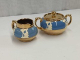 GIBSON ENGLAND CREAM &SUGAR RAISED WHITE FIGURES ON BLUE GOLD TRIM