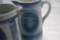 (3) BLUE AND WHITE STONEWARE PITCHERS INCLUDING COWS, BASKETWEAVE AND FLOWE