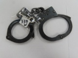 Made in Fond du Lac, Wisconsin by American Handcuff Co.  Handcuffs with Key, black stainless steel