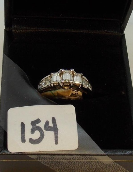 LADIES 14K W/G  3 EMERALD CUT CENTER DIAMONDS WITH PRICESS CUT DIAMONDS ALONG THE SIDE BANDS