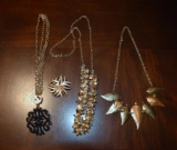 Lot of 4 Pieces of Costume Jewelry: Medallion, Leaves, Other Motifs and Sunburst Brooch