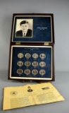 Collection of 16 Kennedy Half Dollars in Display Case & Paper