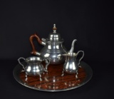 Stieff Pewter “Williamsburg” Footed Tea Pot, Sugar, Creamer & Round Wood Grain Tray