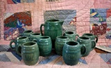 Green Stoneware Unmarked  8.5” H Barrel Pitcher & Ten McCoy Mugs