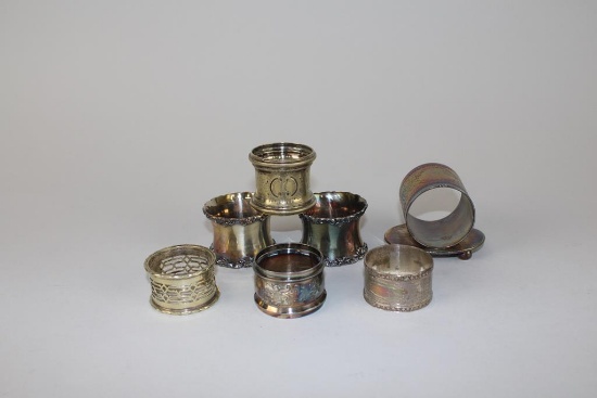 Lot of Seven Silver Plated Napkin Rings: James Tufts & Others
