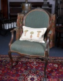 French Style Carved Mahogany Armchair with Green Upholstery and Accent Pillow