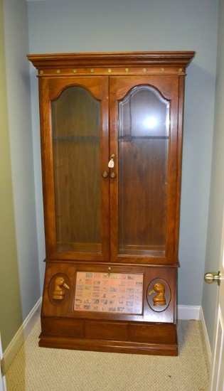 A Ducks Unlimited 12 Gun Lighted Oak Gun Cabinet with Migratory Duck Stamps Print Motif