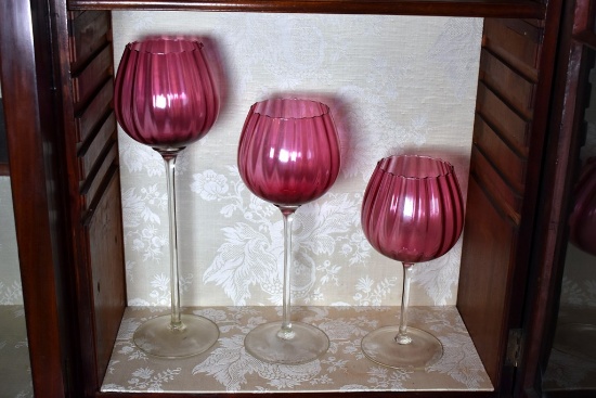 A Set of Three Large Colony Mid-Century Ribbed Optic Cranberry Glass Goblets, Italy