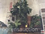 Artificial plants in baskets, wooden vases